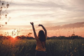woman-waving-her-hands-during-golden-hour.jpg woman waving her hands during golden hour
